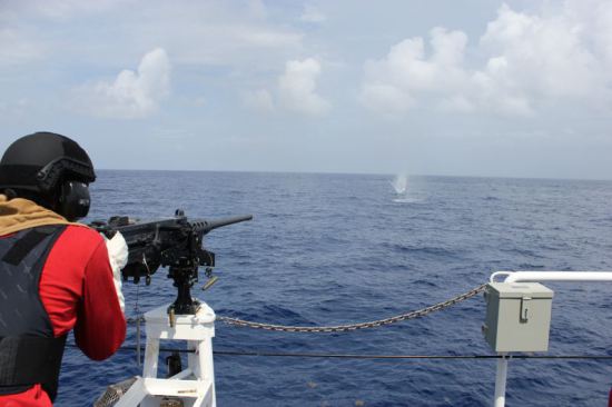 A crew member of the Coast Guard's second Fast Response Cutter, Richard Etheridge, fires a.50 caliber machine gun July 17 during the cutter's first live fire exercise. Richard Etheridge will be commissioned on August 3 in Port Everglades, Fla. and homeported in Miami alongside the first FRC, Coast Guard Cutter Bernard C. Webber. USCG photo by Lt. James Ellsworth.