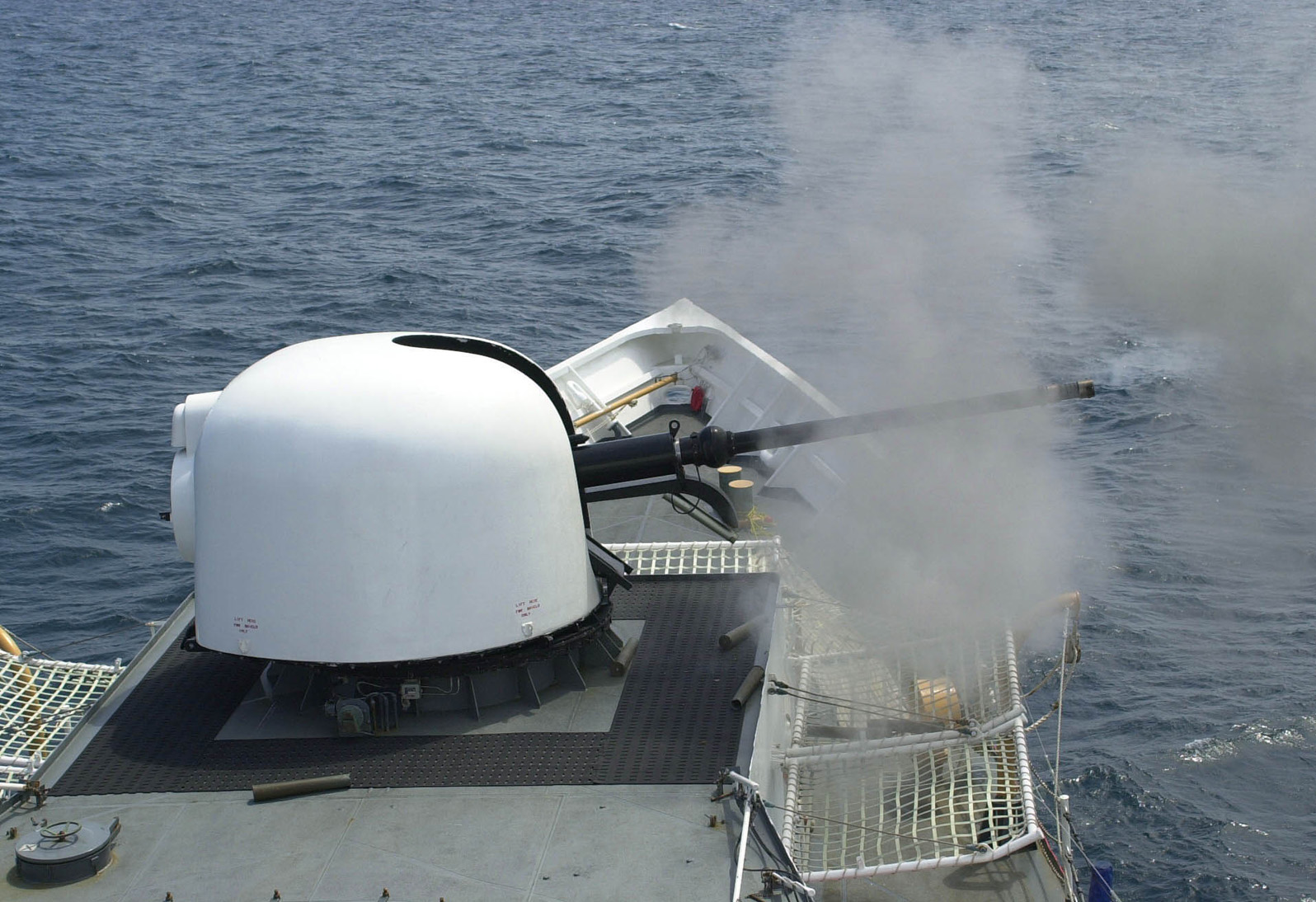 JACKSONVILLE, Fla. (Apr. 26, 2005) The 76mm gun aboard the Coast Guard Cutter Gallatin fires a three-round burst during a live-fire exercise off the coast of Mayport, Fla., April 26, 2005. The MK 75 can fire up to 80 rounds a minute and has a range of approximately 10 nautical miles. The Gallatin is a 378-foot cutter homeported in Charleston, S.C. and is in Mayport for Tailored Annual Cutter Training (TACT). U.S. Coast Guard photo by PA3 Bobby Nash.