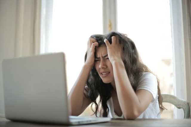 Frustrated Woman Looking at Website