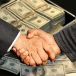 Men Shaking Hands - Money in Background