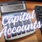 Calculator in foreground with title capital accounts