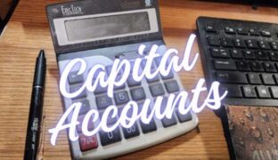 Calculator in foreground with title capital accounts