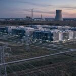 AI data center with nuclear power plant in the background