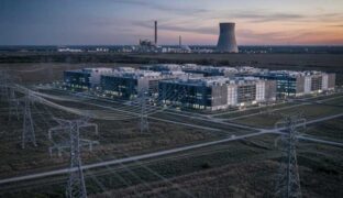 AI data center with nuclear power plant in the background