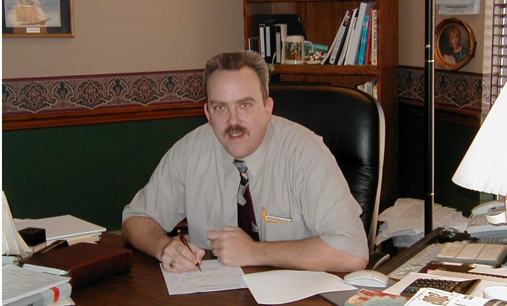 Steven Imke sitting behind a desk