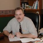 Steven Imke sitting behind a desk