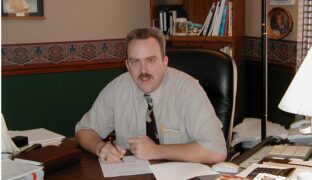 Steven Imke sitting behind a desk